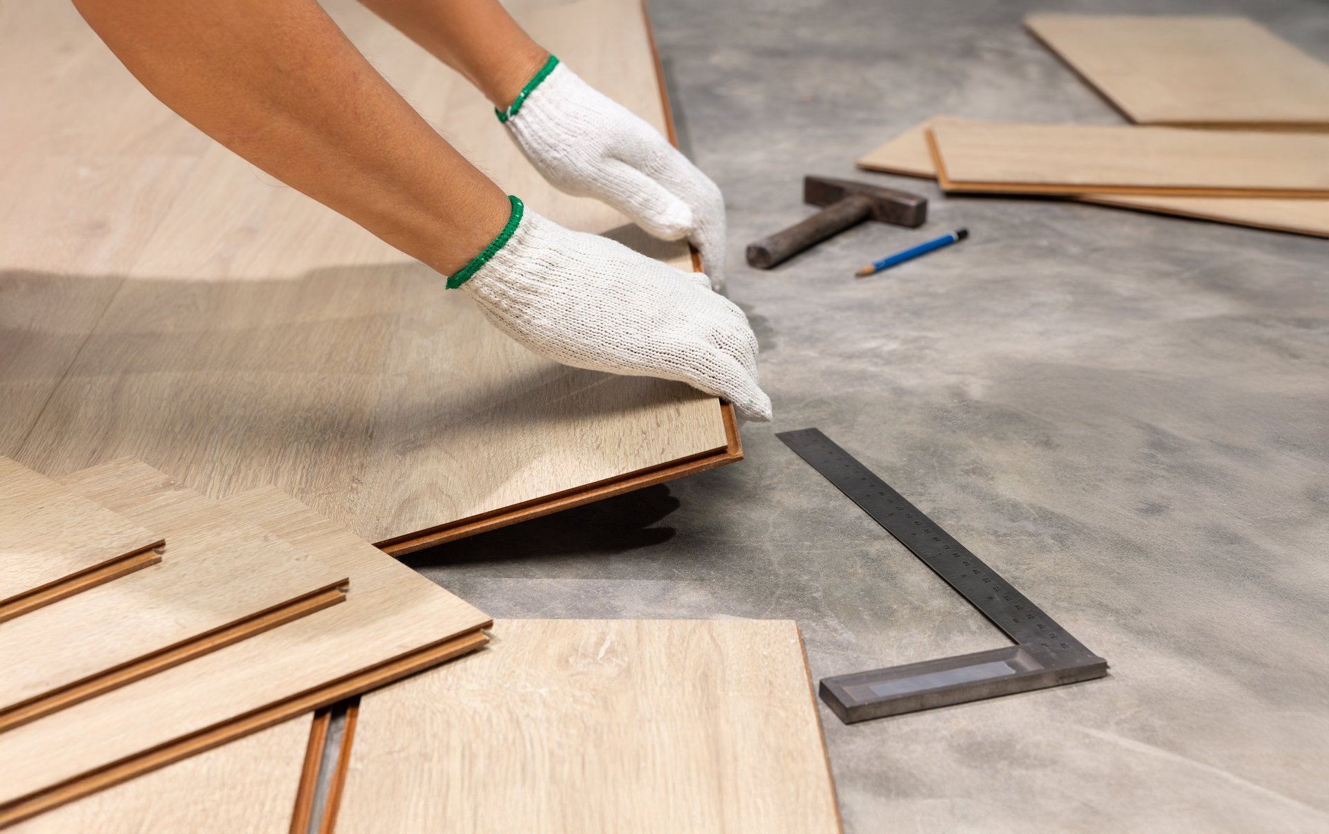 Worker Installing laminate flooring in a modern home